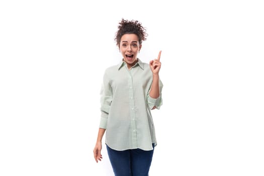 young woman with curly messy hairstyle is inspired by the idea.