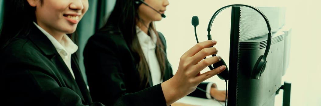 Business people wearing headset working in office to support remote customer or colleague. Call center, telemarketing, customer support agent provide service on telephone video conference oratory call