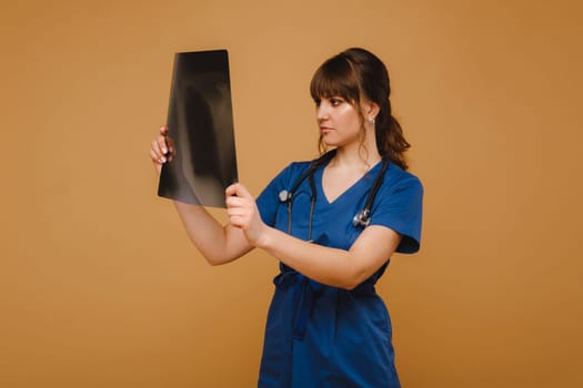 Female Brunette Doctor Looking at Tomography X-ray Film.