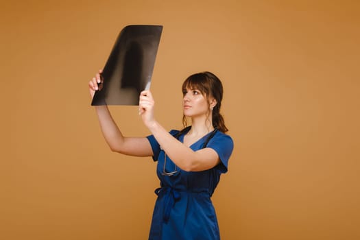 Female Brunette Doctor Looking at Tomography X-ray Film.