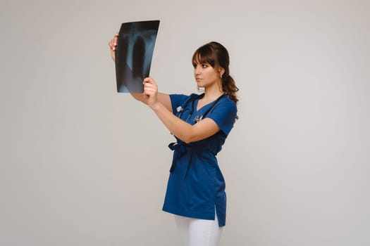 Female Brunette Doctor Looking at Tomography X-ray Film.