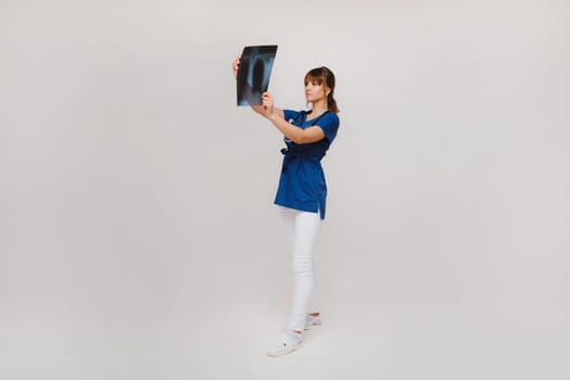 Female Brunette Doctor Looking at Tomography X-ray Film.