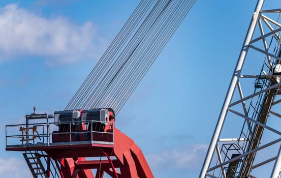 Focus on detail of cables and gears of heavy industrial crane jib used to restore dam on Mississippi