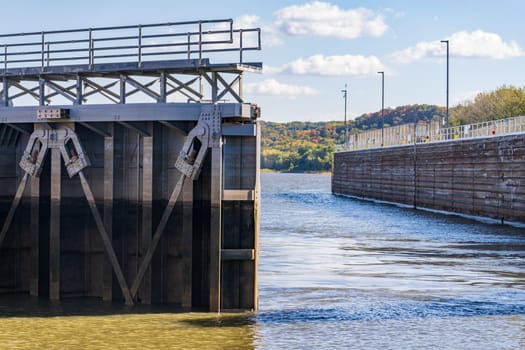 Lock gates opening as cruise boat sailes out of the Lock and Dam no. 12 on Upper Mississippi near Hannibal Missouri in the fall