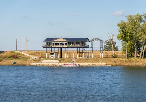 Modern home on very tall structure of stilts by the Mississippi river to protect against high water and floods