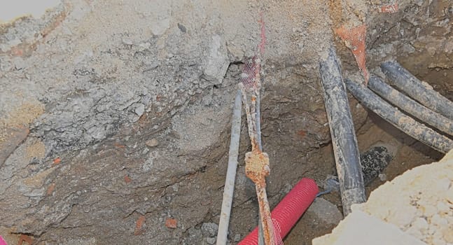 Cables in the trench. Cables in the excavation ready for electrical installation. Concept of electrical installations, construction work, building renovations and building renovations.