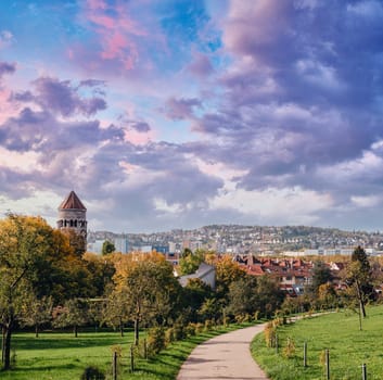 Germany, Stuttgart panorama view. Beautiful houses in autumn, Sky and nature landscape. Vineyards in Stuttgart - colorful wine growing region in the south of Germany with view over Neckar Valley. Germany, Stuttgart city panorama view above vineyards, industry, houses, streets, stadium and highway at sunset in warm orange light.