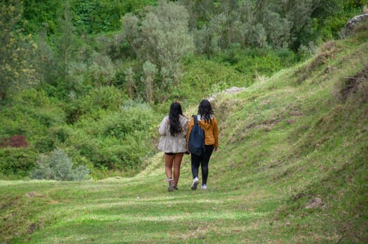 a couple of friends walking side by side on a trail in Ecuador enjoying their vacations and rural tourism. High quality photo