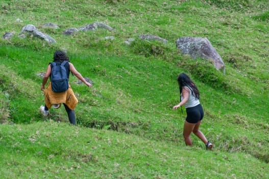 two friends climbing among rocks on a dangerous mountain in ecuador, south america. High quality photo
