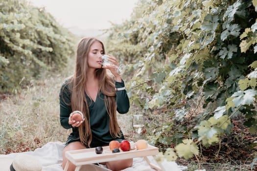 Picnic and wine tasting at sunset in the hills of Italy, Tuscany. Vineyards and open nature in the summer. Romantic dinner, fruit and wine.