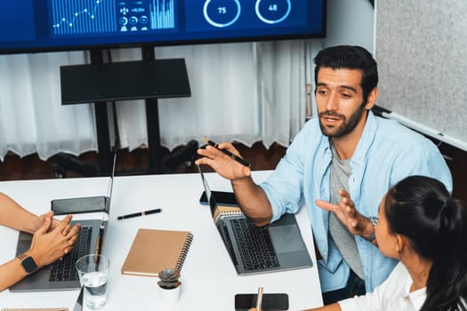 Analyst team utilizing BI Fintech to analyze financial data at table in meeting room. Businesspeople analyzing BI dashboard power on paper for business insight and strategic marketing planning.Prudent