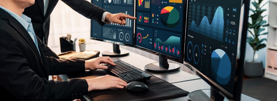 Analyst working on data analysis or BI dashboard on computer monitor. Business team analyzing financial data by Fintech in corporate office for business marketing and strategy planning. Trailblazing