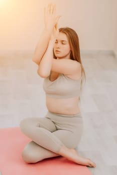 Group of young womans fitness instructor in Sportswear Leggings and Tops, stretching in the gym before pilates, on a yoga mat near the large window on a sunny day, female fitness yoga routine concept.