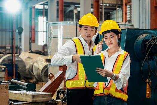 Professional quality control inspector conduct safety inspection on machinery and manufacturing process in factory. Engineers overseeing process optimization in heavy industry facility. Exemplifying