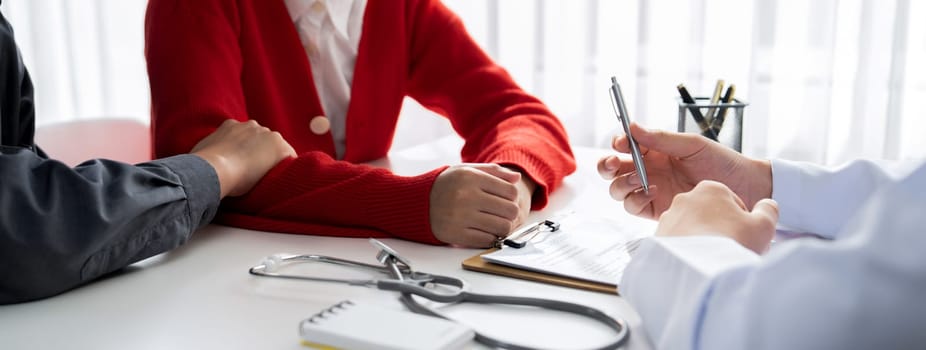 Couple attend fertility or medical consultation with gynecologist at hospital as family planning care for pregnancy. Husband and wife consoling each other through doctor appointment. Panorama Rigid