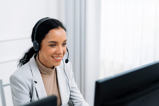 African American young businesswoman wearing headset working in office to support remote crucial customer or colleague. Call center, telemarketing, customer support agent provide service on video call