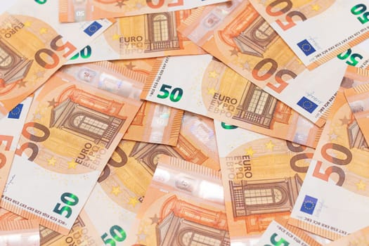 50 Euro Banknotes Money Background. Euro Money Currency. Orange Paper Money. A Lot of Fifty Euro Bills. Business, Finances, Cash and Money Saving Concept