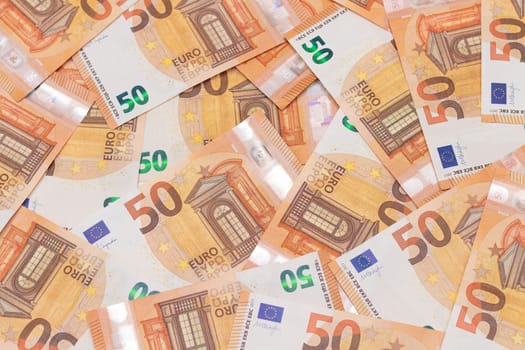 50 Euro Banknotes Money Background. Euro Money Currency. Orange Paper Money. A Lot of Fifty Euro Bills. Business, Finances, Cash and Money Saving Concept