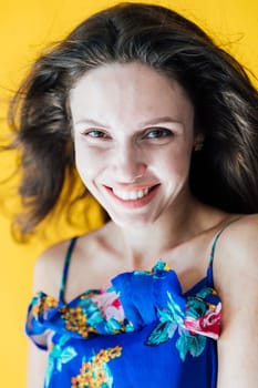 Portrait of a brunette woman on a yellow background