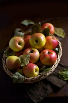 Top view on a ripe apples on a wooden table in basket