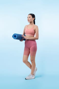 Young attractive asian woman portrait in sportswear with exercising mat. Healthy exercise and workout routine lifestyle concept. Studio shot isolated background. Vigorous