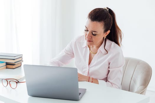 woman recording information from laptop
