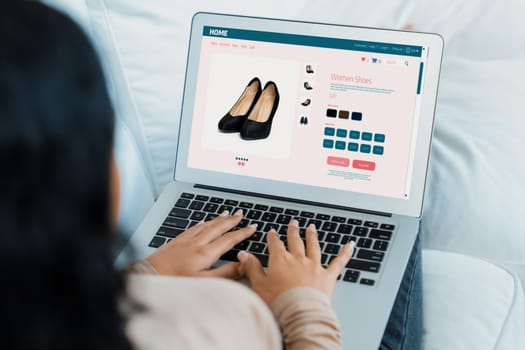 Woman shopping online on internet marketplace browsing for sale items for modern lifestyle and use credit card for online payment from wallet protected by crucial cyber security software