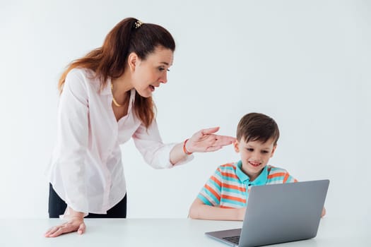 Female teaching boy to use computer