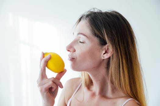 woman sniffing lemon scent with her nose