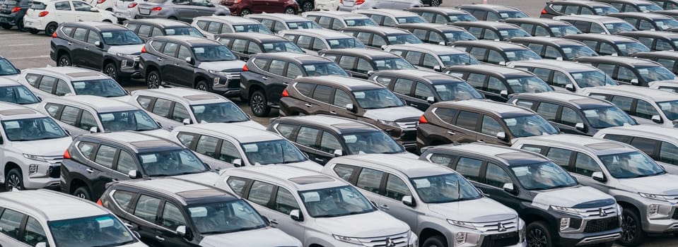 Lamchabang, Thailand - July 02, 2023 In a busy car factory warehouse, numerous brand new cars stand ready for global distributiona glimpse into the modern world of car manufacturing.