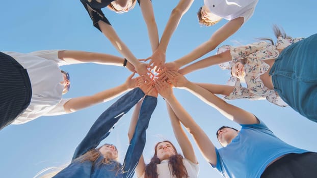 Friends putting their hands together in a sign of unity and teamwork. Just the hands