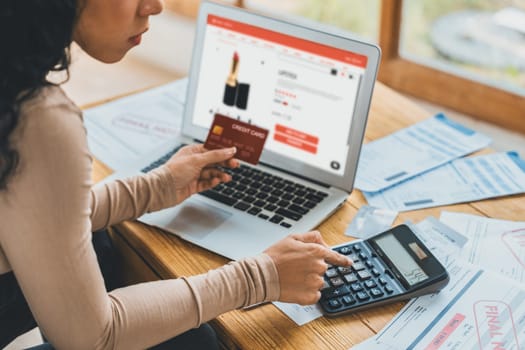 Woman shopping online on internet marketplace browsing for sale items for modern lifestyle and use credit card for online payment from wallet protected by crucial cyber security software