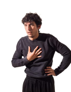 A young attractive man with his hands on his chest, suffering from heart pain, heartache, heartburn or chest pain, isolated on white