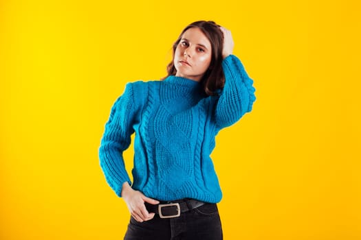 Brunette woman posing on yellow