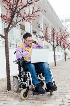 A person with with a laptop and a phone