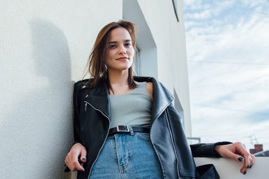 Woman in jeans posing on balcony room