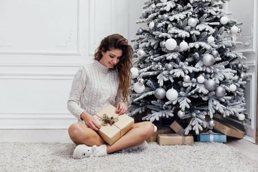 Woman decorating christmas tree for new year