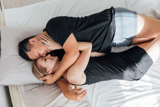 Husband and wife sleeping together in bed