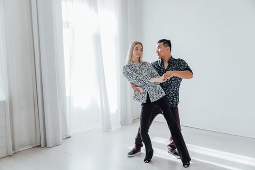 man and a woman dancing in a coach's studio