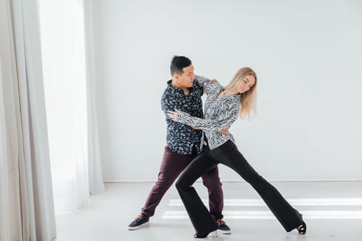 man and a woman dancing in a coach's studio