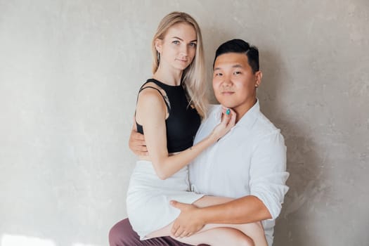 A couple of lovers, a man and a woman, sitting in a room