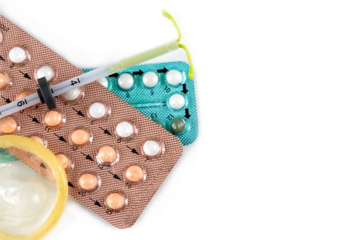 Pregnancy test and birth control pills on calendar, contraception health and medicine.