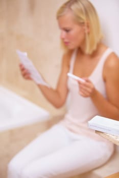 Reading, worry and woman with pregnancy test in bathroom waiting for results, news and instructions. Motherhood, pregnant and person with medical testing kit for fertility, ivf or ovulation at home.