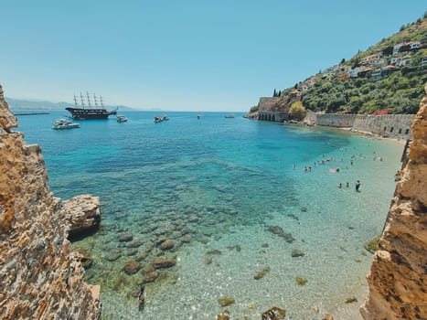 view from the wall of the old Alanya fortress to a beautiful beach and ships, soft focus. concept of summer vacation, beach holiday