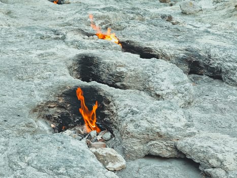 fire from the mountain, stones are burning, the flame of the Chimera shoots out from under the ground. Natural gas fire in rocks in Cirali, Turkey.