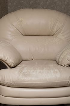 Defects on a white leather sofa. Damaged to leather furniture. Close up of damaged white leather soft tufted furniture. Bad quality leather