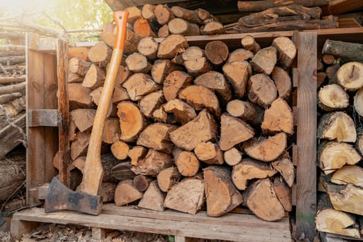 Organized woodshed prepared with different kinds of wood to use in the fireplace at home in winter. High quality photo