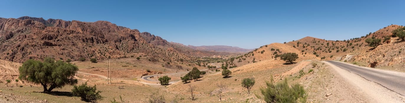 Great panoramic landscape of the Anti-Atlas mountains in the Taourirt region, a road winding through the mountains, Morocco