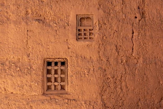 Two little windows in a typical berber house built of clay, Draa valley in Morocco