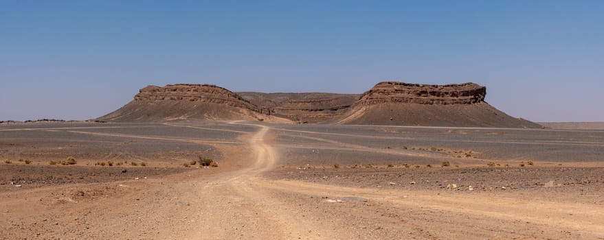 Iconic horseshoe mountain Gara Medouar in the desert near Merzouga, known for different film sets, Morocco